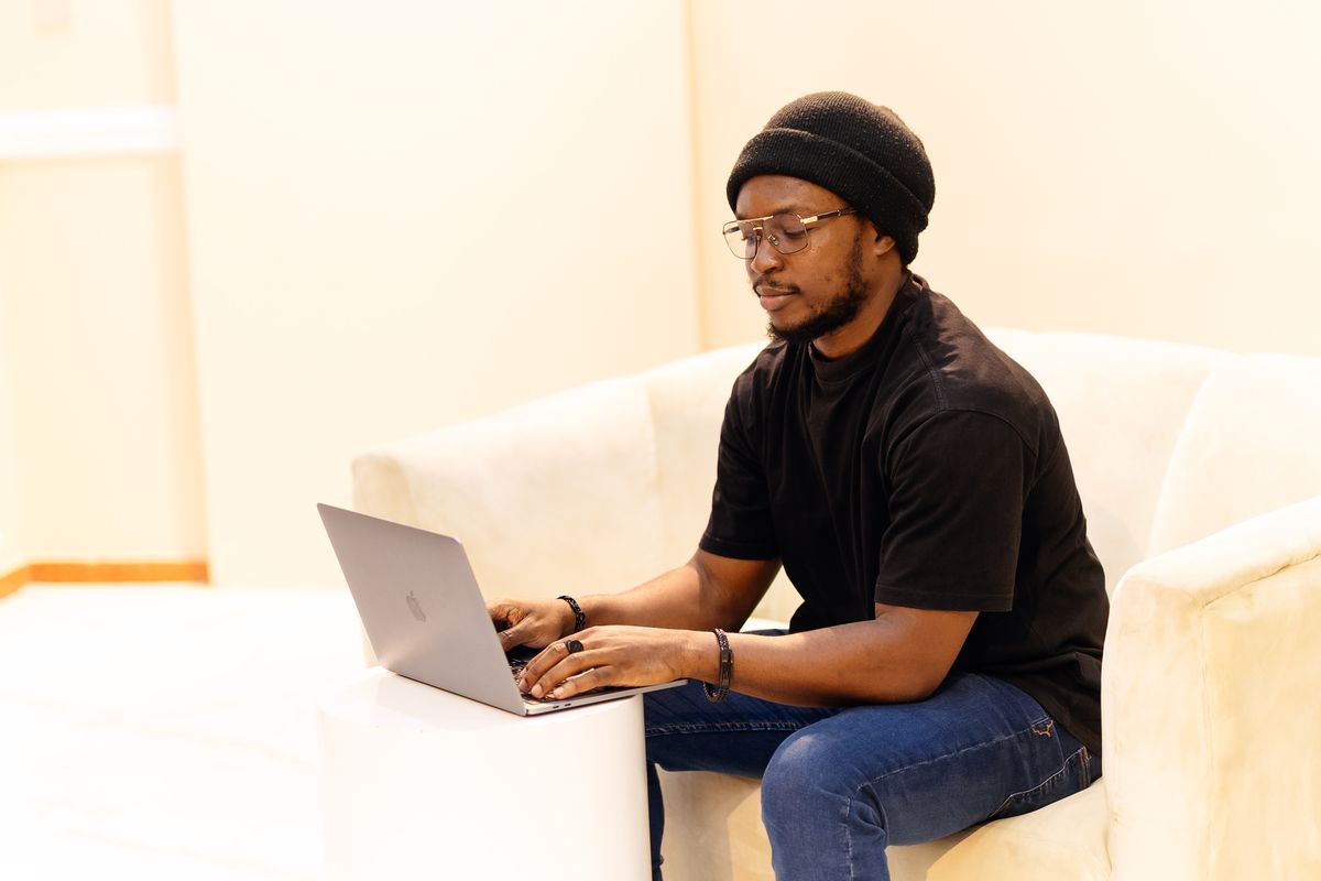 African technology professional working on a laptop